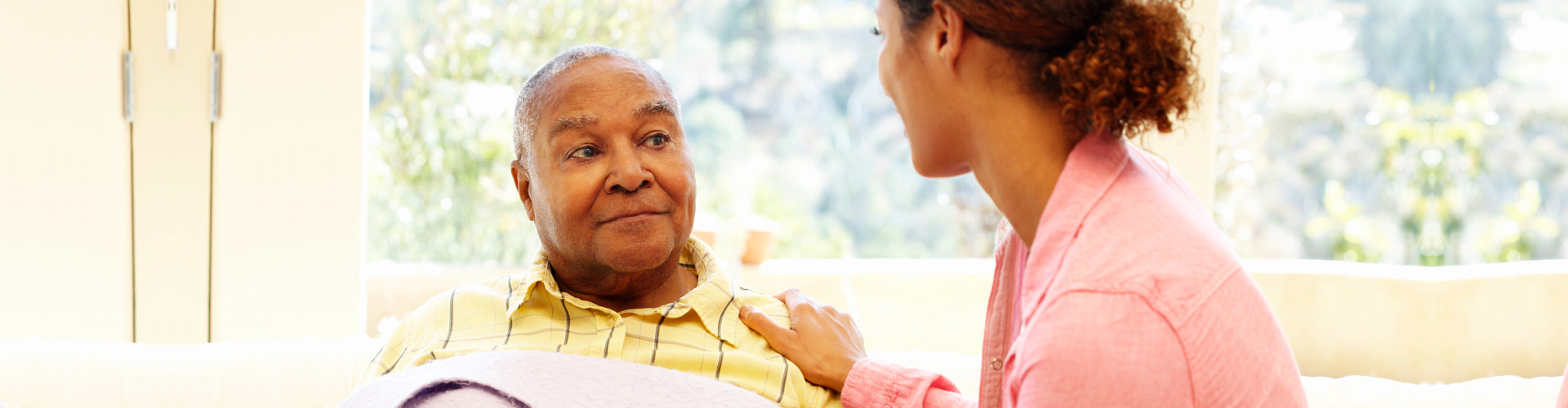 caregiver comforting senior man