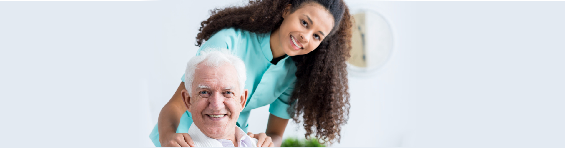 caregiver and senior man smiling