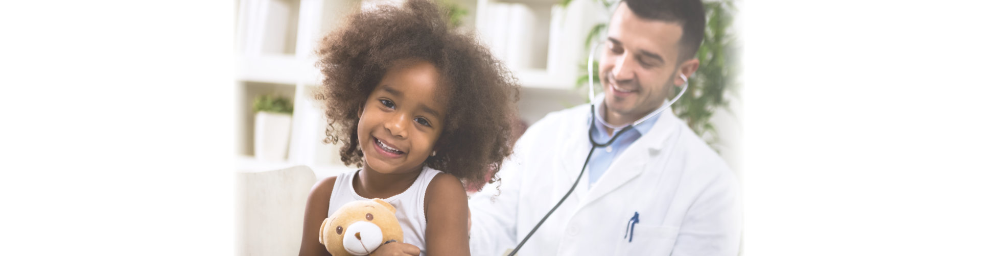 Beautiful smiling afro-american girl with her pediatrician at office