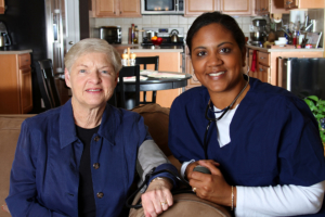 caregiver and senior woman smiling