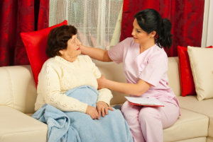 caregiver comforting senior woman