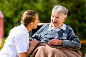 caregiver comforting senior woman